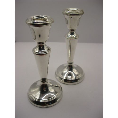 191 - A pair of sterling silver candlesticks hallmarked for Birmingham 1978 by AC & Sons Ltd, 16cm high