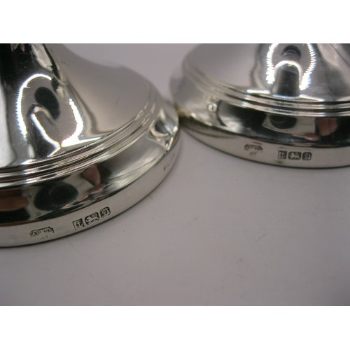 191 - A pair of sterling silver candlesticks hallmarked for Birmingham 1978 by AC & Sons Ltd, 16cm high