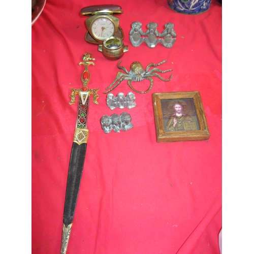 275 - A selection of metalwork and other items including 3 sets of brass monkeys, a paper knife and a reli... 