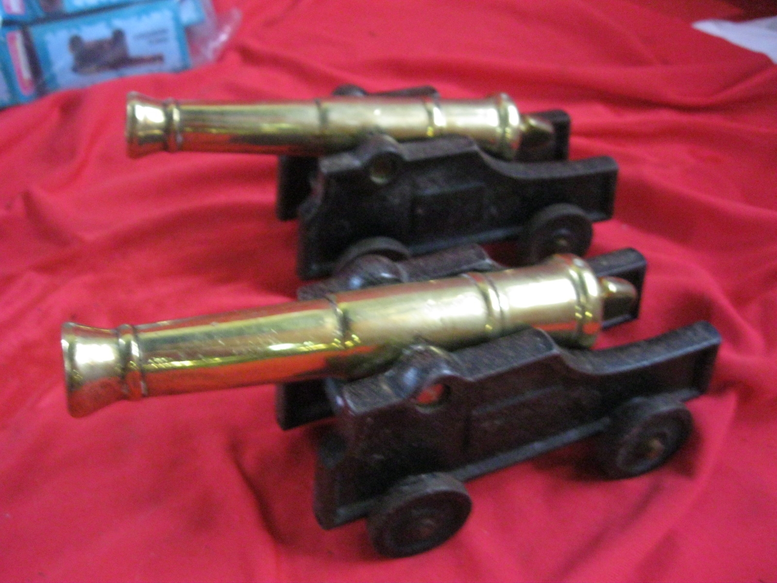 A pair of brass ship's cannon on wooden trunnions, approx 8" long