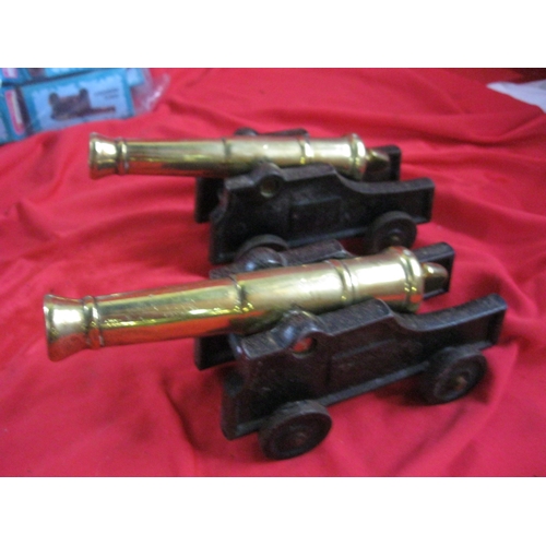 A pair of brass ship's cannon on wooden trunnions, approx 8" long