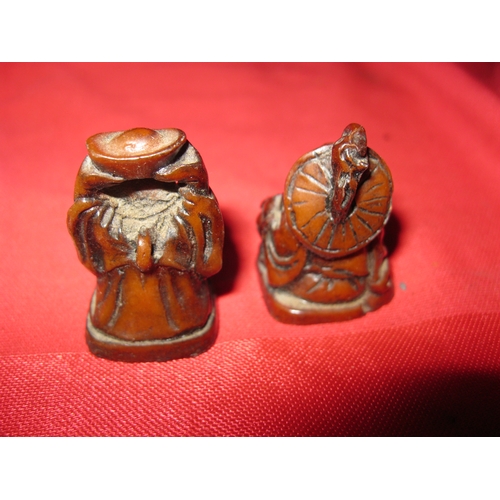 360 - A small pair of resin Buddha netsuki approx 1