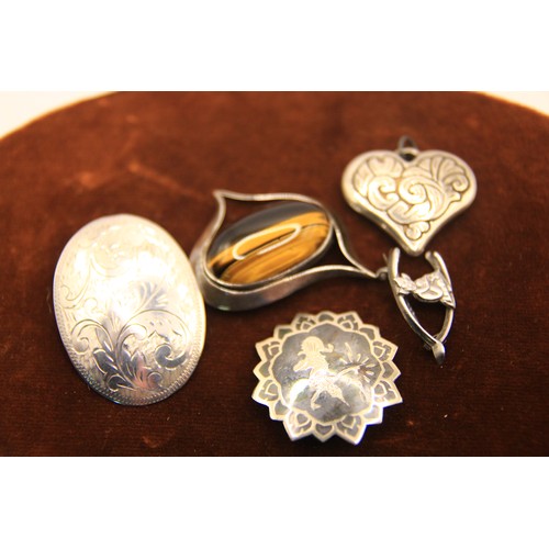 76 - A bag of silver brooches including a wishbone pixie brooch