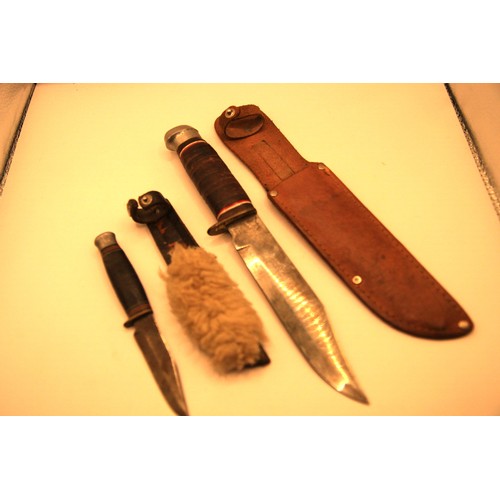 83 - A pair of sheath knives, the larger marked 'The Original Bowie Knife', the smaller a Scout knife by ... 