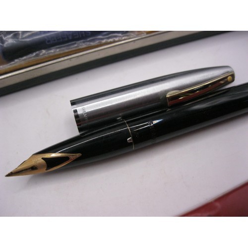 246 - A cased Sheaffer cartridge ink pen with a 14 carat gold nib, a boxed Sheaffer ballpoint branded for ... 