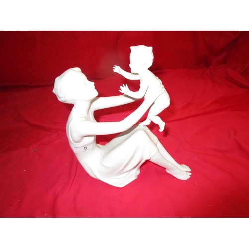 5 - A Lovely Kaiser Porcelain figurine of a sitting Mother and her child .
Eight inches by 8 inches.