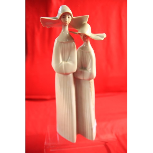 8 - A lovely Pair of LLadro European  Nuns  in pristine condition  12 inches tall