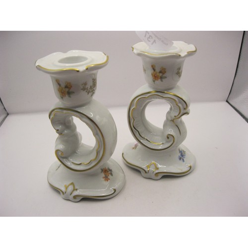 137 - Pair of Weimar Porzellan white porcelain candlesticks, scrolled stem, gilding and decorated with flo... 
