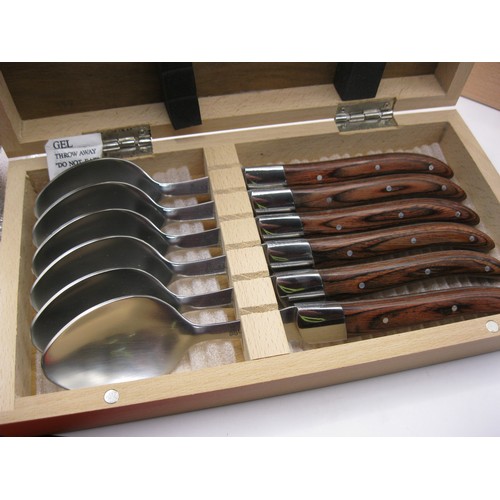 161 - Two sets of six spoons by Laguiole in wooden carry/storage  boxes along with a glass decanter brande... 