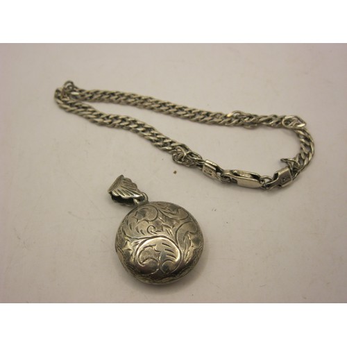 192 - A sterling silver locket, round, with floral engraved design, and a sterling silver bracelet