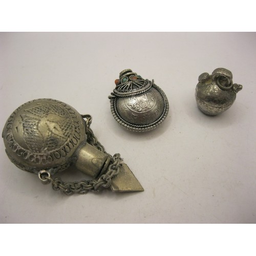 244 - Three white metal scent bottles
