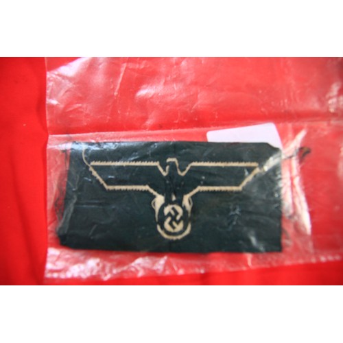 10 - A German Nazi 'Staatsadler' patch in black and silver on a green backing, reputedly brought back fro... 