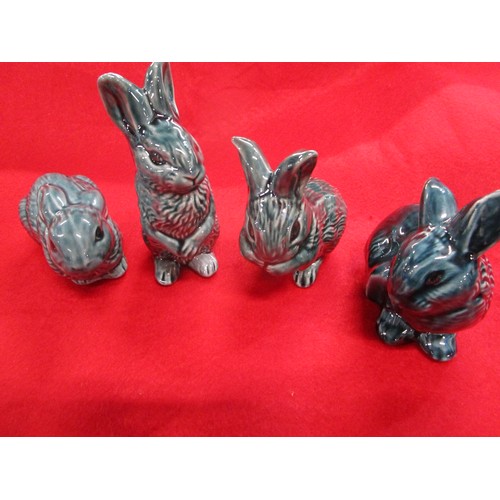 33 - A full set of Poole Pottery Dolphin blue rabbits including the harder to find standing rabbit.