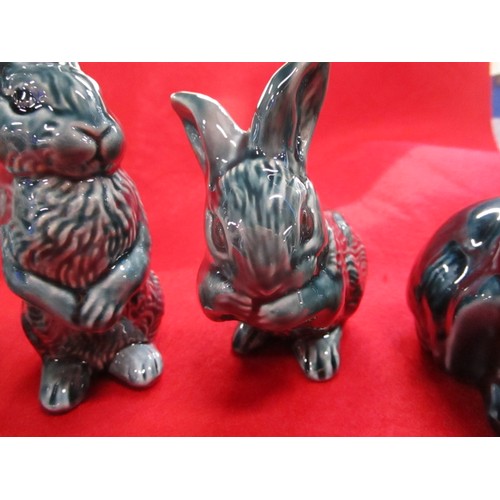 33 - A full set of Poole Pottery Dolphin blue rabbits including the harder to find standing rabbit.