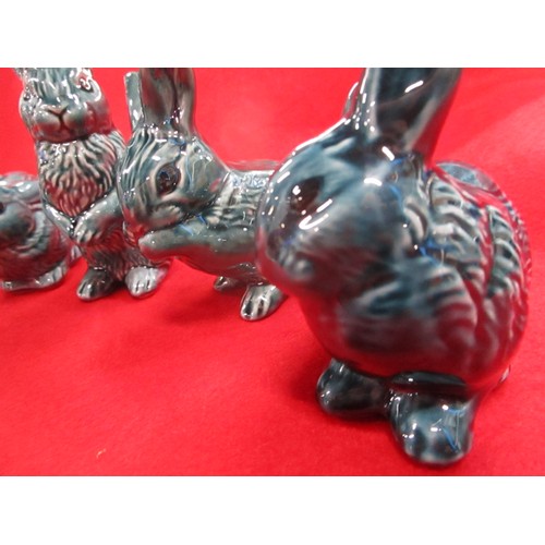 33 - A full set of Poole Pottery Dolphin blue rabbits including the harder to find standing rabbit.