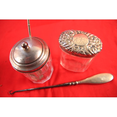 74 - A pair of glass jars with sterling silver tops, one a jam or honey jar hallmarked for Sheffield 1910... 