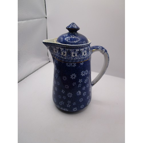 86 - Early Shelley Cloisello Ware jug in pristine condition apart from one lid holding lug missing.
The j... 