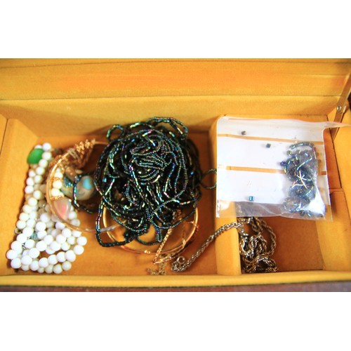 128 - Felt covered musical jewellery box two tier with sectional ring holder. Box contains  a samll select... 