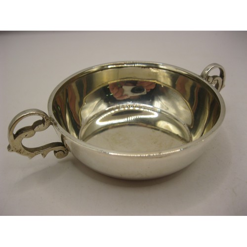 285 - A sterling silver tastevin, double-handled, hallmarked for Chester 1937, maker's mark polished away ... 