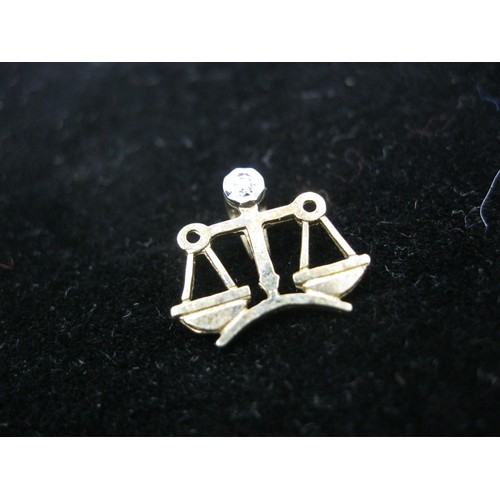 290 - A 9 carat gold pendant in the form of scales set with a small diamond at the pivot, approx weight <1... 