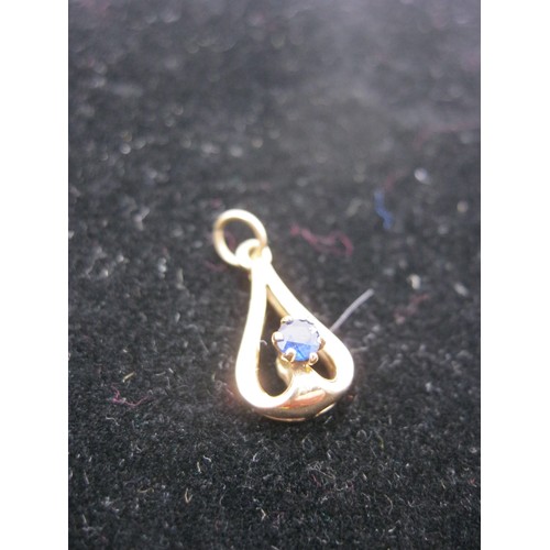 291 - A 9 carat gold pendant set with likely a sapphire, approx weight <1g