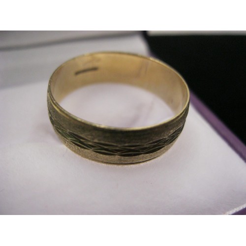 294 - A 9 carat gold wedding band, size W, approx weight 2.64g, attractive diamond cut design and quite su... 