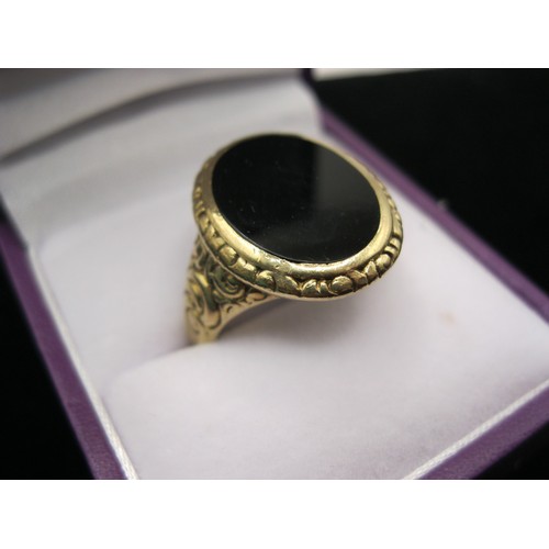 295 - A substantial gentleman's signet ring in 9 carat gold, black stone and nicely engraved decoration, s... 