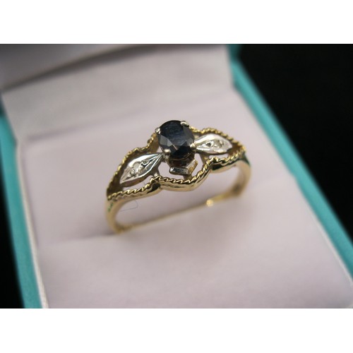 297 - A 9 carat gold ring set with a sapphire flanked by diamonds in a fluted mount, size P/Q, approx weig... 