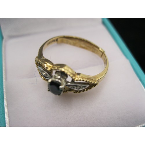 297 - A 9 carat gold ring set with a sapphire flanked by diamonds in a fluted mount, size P/Q, approx weig... 