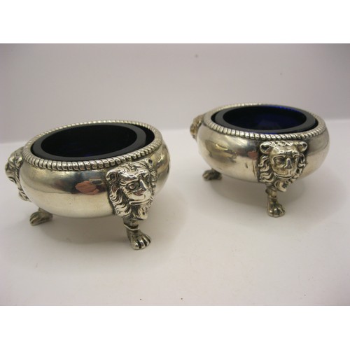 247 - A pair of George II silver salts with cobalt blue glass inserts, with lions mask feet and fluted rim... 