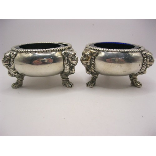 247 - A pair of George II silver salts with cobalt blue glass inserts, with lions mask feet and fluted rim... 