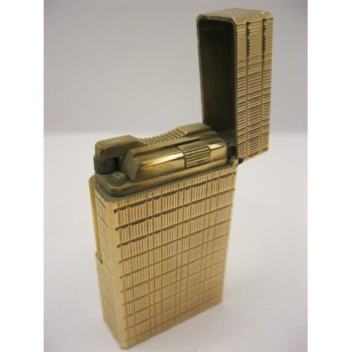 248 - A heavy gold plated cigarette lighter by S T Dupont of Paris, in apparent working order, very clean ... 