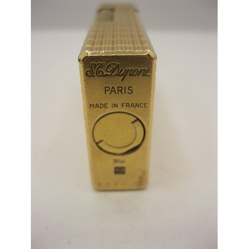 248 - A heavy gold plated cigarette lighter by S T Dupont of Paris, in apparent working order, very clean ... 