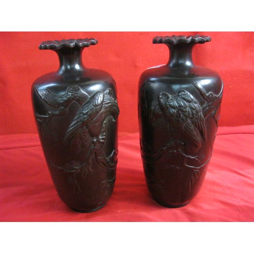 207 - A pair of unpolished Bronze Japanese Meiji period vases decorated with a bird, possibly an eagle, in... 