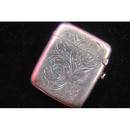 82 - An antique sterling silver vesta case with floral decoration to exterior and integral striker to bas... 