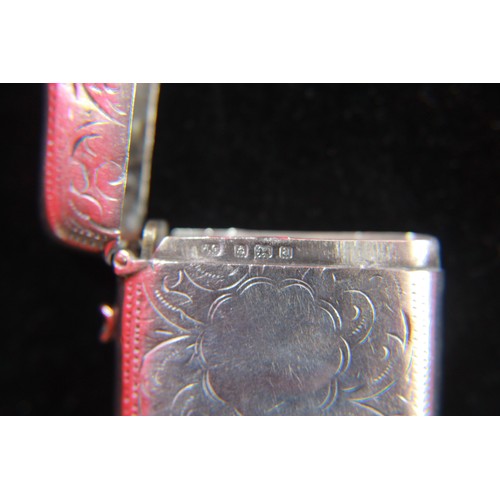 82 - An antique sterling silver vesta case with floral decoration to exterior and integral striker to bas... 