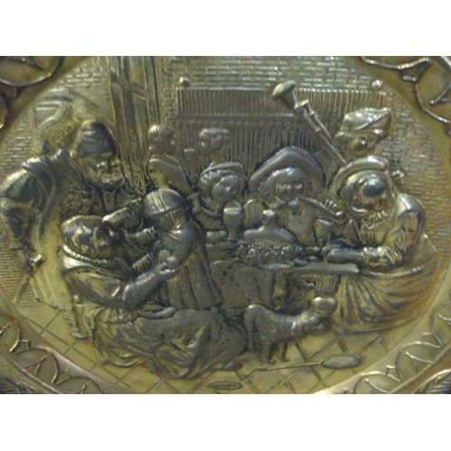 106 - Large circular brass tray or platter embossed with an Elizabethan tavern scene, diameter about 72cm