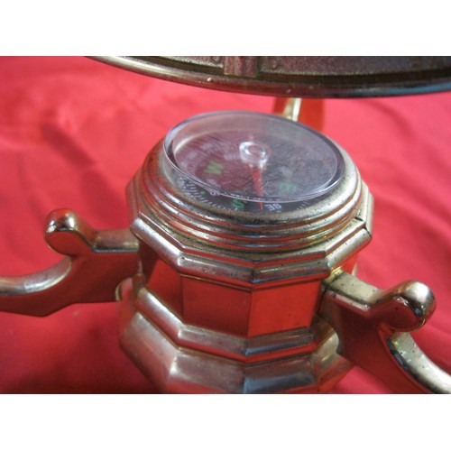 159 - A modern and decorative tabletop globe with a simulated specimen stone inlay and a brass coloured me... 