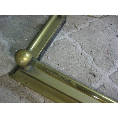 87 - A plain brass rail and ball fire kerb, length 125cm, depth 30cm approx.