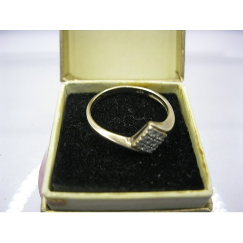 188 - A 9 carat gold ring with geometric pattern of diamonds of .1ct, total weight approx 1.81g, size P