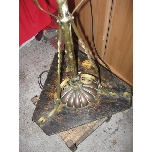 101 - An antique brass standard lamp supported on three scrolled and twisted struts with a central copper ... 