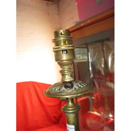 101 - An antique brass standard lamp supported on three scrolled and twisted struts with a central copper ... 