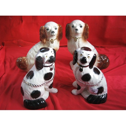 196 - Two pairs of reproduction Staffordshire style pottery spaniels - a black and white example, the othe... 