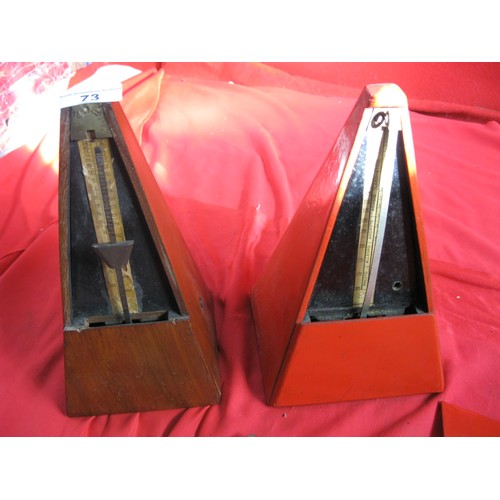 73 - A pair of antique metronomes