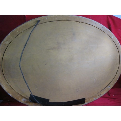 74 - A large oval mirror