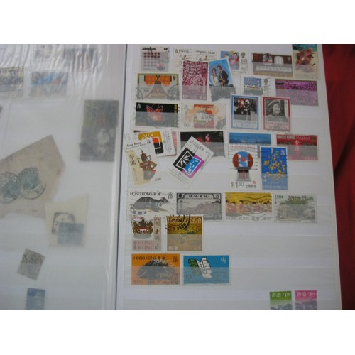 241 - A large stack comprising stockbooks containing mainly UK stamps, stamp collecting albums and supplie... 