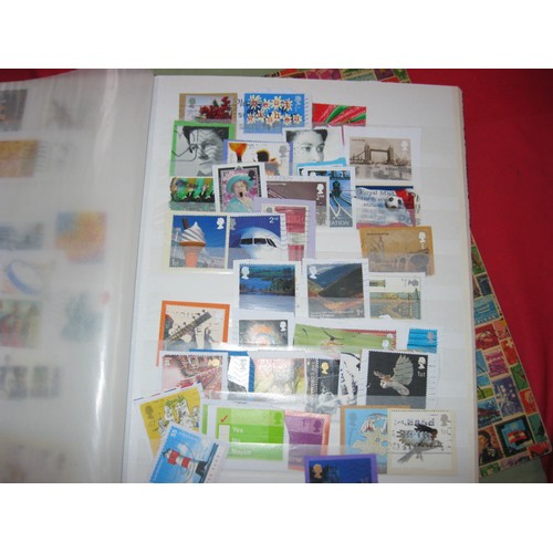 241 - A large stack comprising stockbooks containing mainly UK stamps, stamp collecting albums and supplie... 