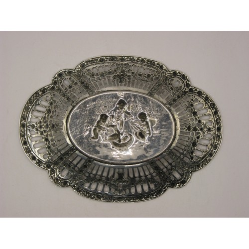 215 - A pierced silver bon-bon dish of Swedish manufacture decorated with a relief of cupid and cherubs, S... 