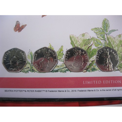 24 - An assortment of Beatrix Potter commemoratives, including a pair of first day cover and coin packs, ... 