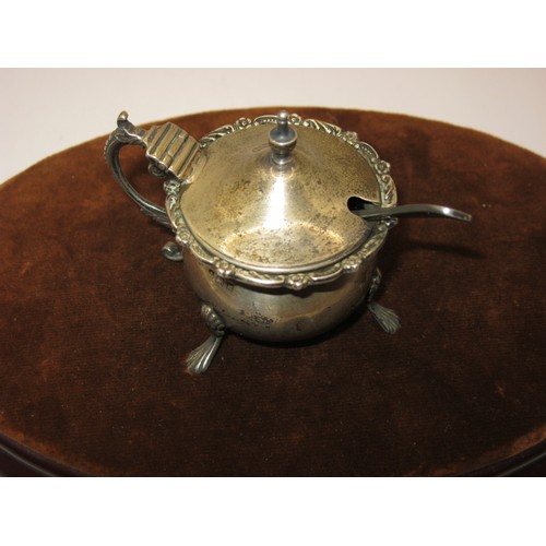 36 - Ornate Silver Mustard Pot on three paw feet, with blue glass liner (spoon is silver plate) 50gm